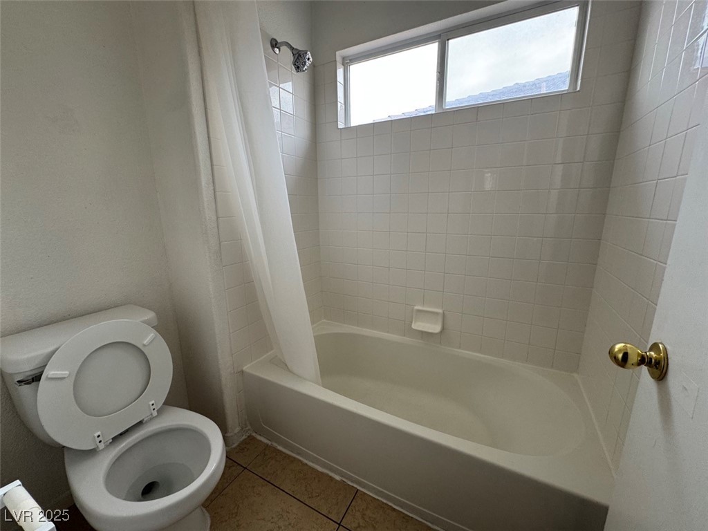 9915 Ridge Hill Avenue Las Vegas, NV 89147 - Photo 11 of 17 Bathroom featuring light tile patterned floors and shower / tub combo