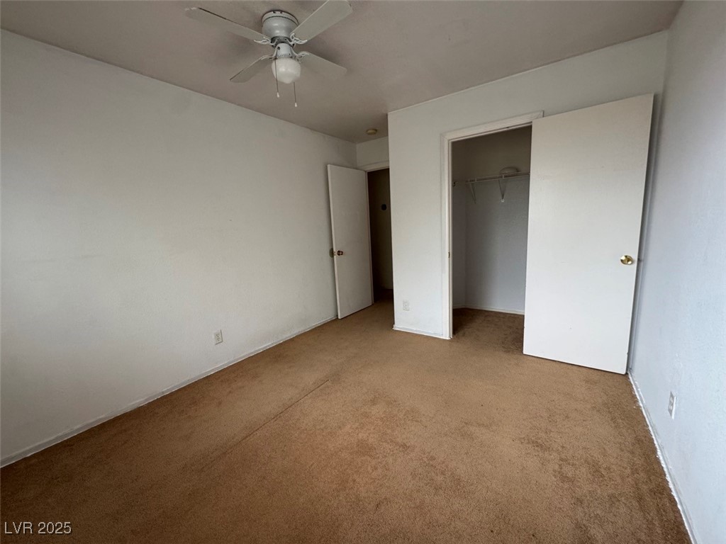 9915 Ridge Hill Avenue Las Vegas, NV 89147 - Photo 13 of 17 Unfurnished bedroom with carpet floors, a closet, and ceiling fan