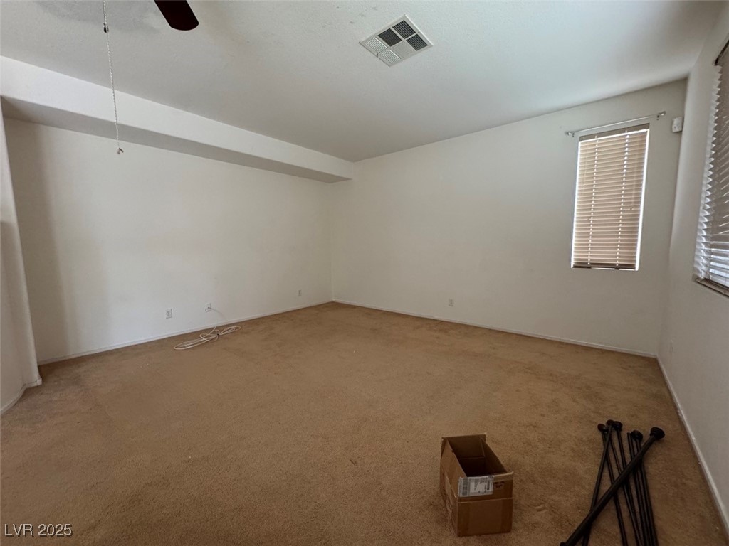 9915 Ridge Hill Avenue Las Vegas, NV 89147 - Photo 5 of 17 Carpeted spare room with ceiling fan and baseboards