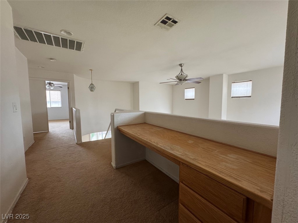9915 Ridge Hill Avenue Las Vegas, NV 89147 - Photo 8 of 17 Unfurnished office with ceiling fan, dark colored carpet, and healthy amount of natural light