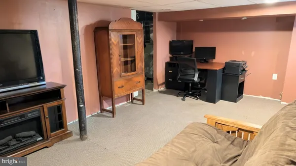 a view of a livingroom with furniture and a flat screen tv