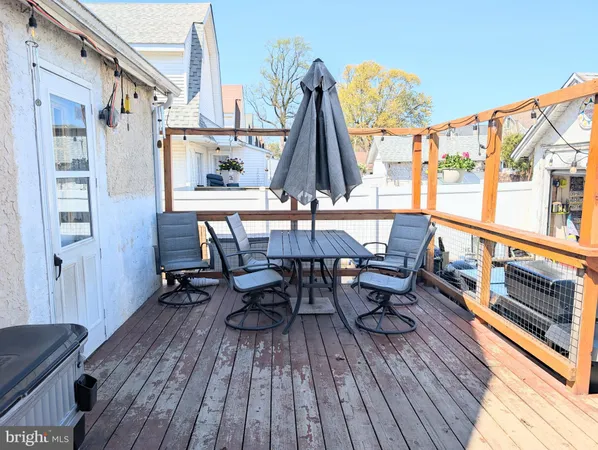 a view of deck with table and chairs