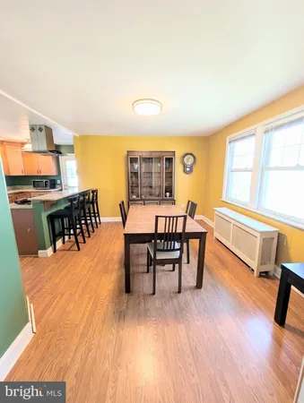 a dining room with furniture and wooden floor