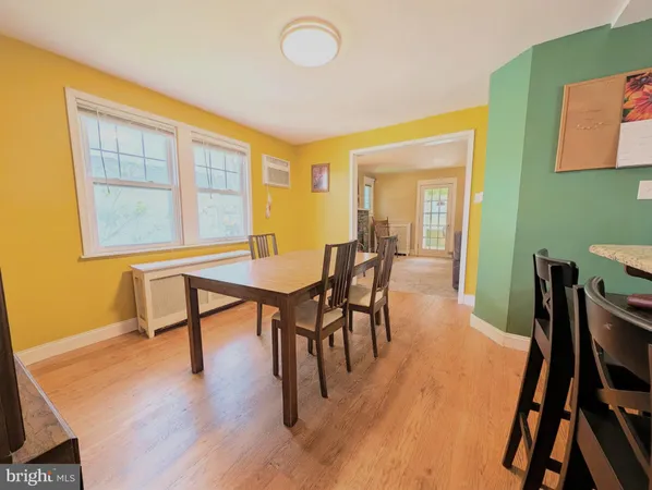 a view of a dining room with furniture and a window