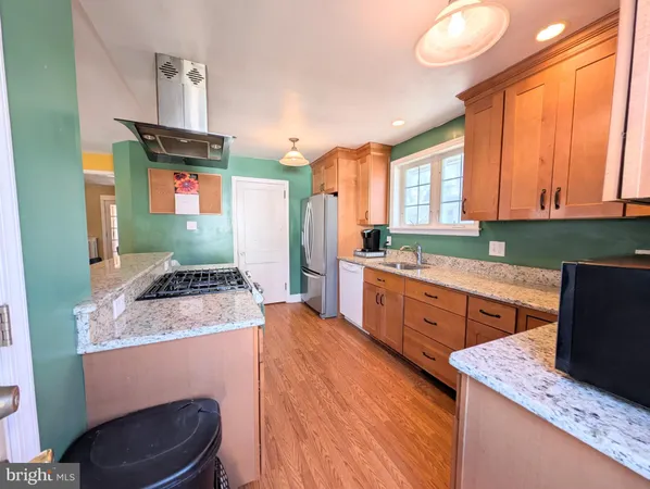 a kitchen with sink refrigerator and cabinets