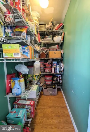 a utility room with lots of clutter and chairs