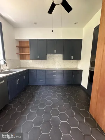 a kitchen with kitchen island a sink a counter and cabinets