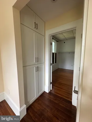 a view of a hallway with wooden floor and entryway
