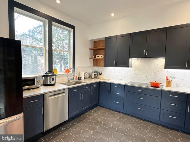 a kitchen with a sink a window and wooden cabinets