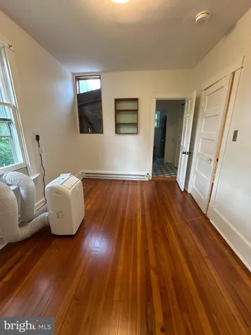 a room with wooden floor and glass door
