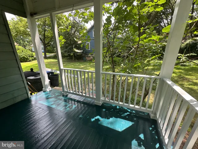 a view of a balcony with chair and wooden floor