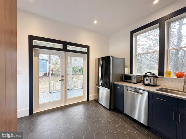 a kitchen with stainless steel appliances a stove sink and refrigerator