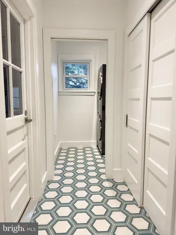 a bathroom with a glass door shower and a sink