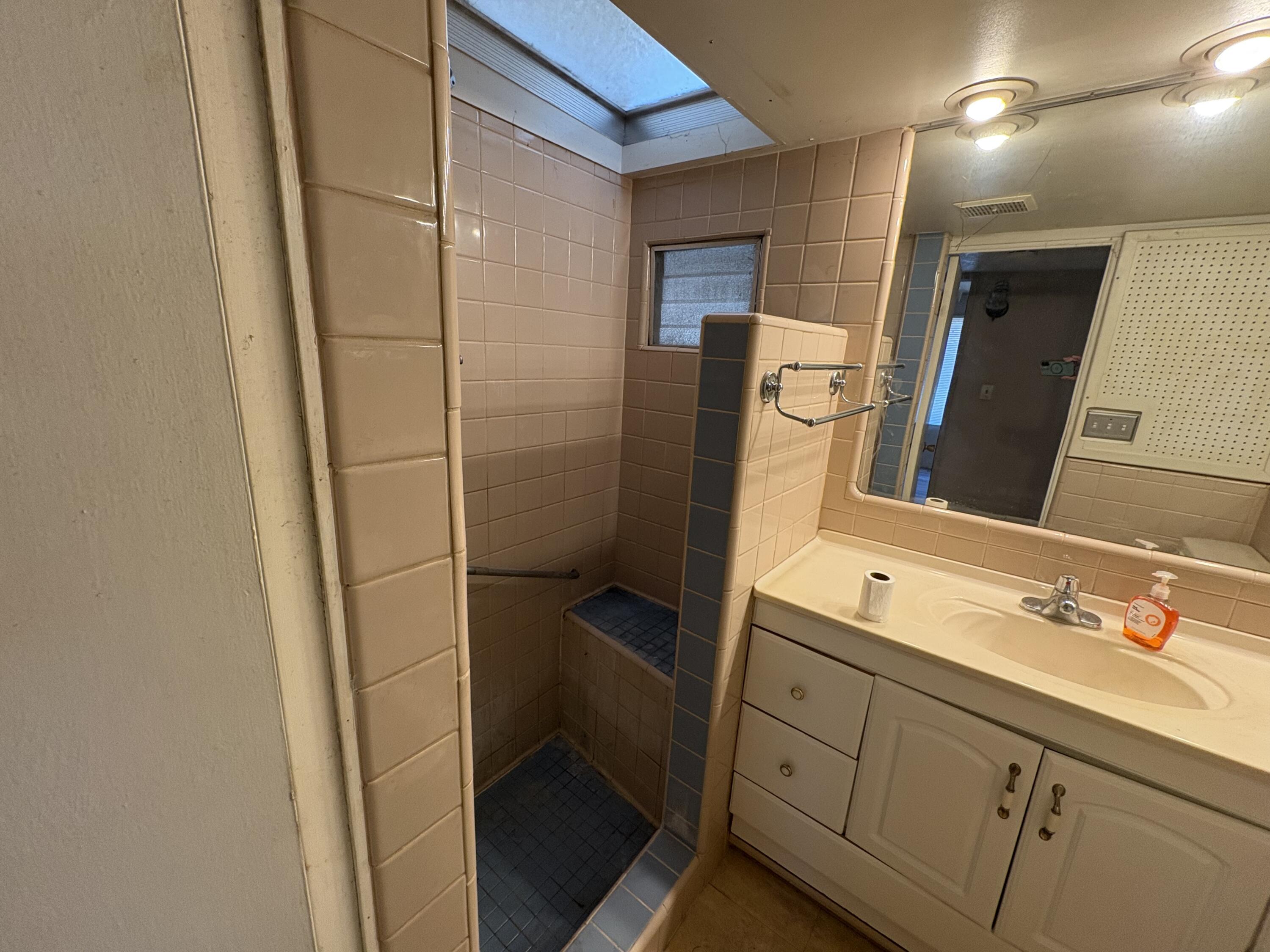 70260 Highway 111, Unit 148 Rancho Mirage, CA 92270 - Photo 23 of 36 a bathroom with a double vanity sink and mirror