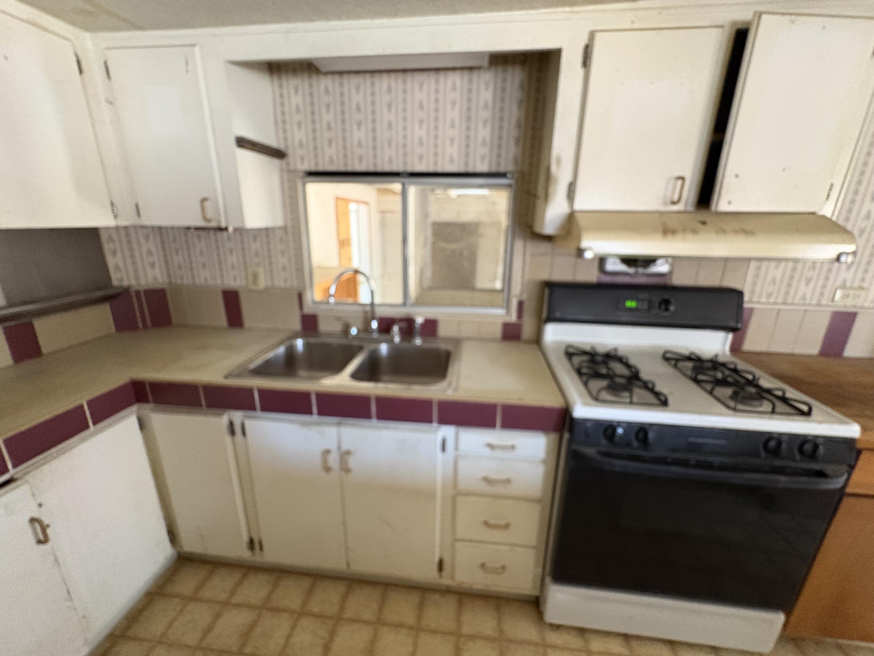 70260 Highway 111, Unit 148 Rancho Mirage, CA 92270 - Photo 25 of 36 a kitchen with a stove and a sink