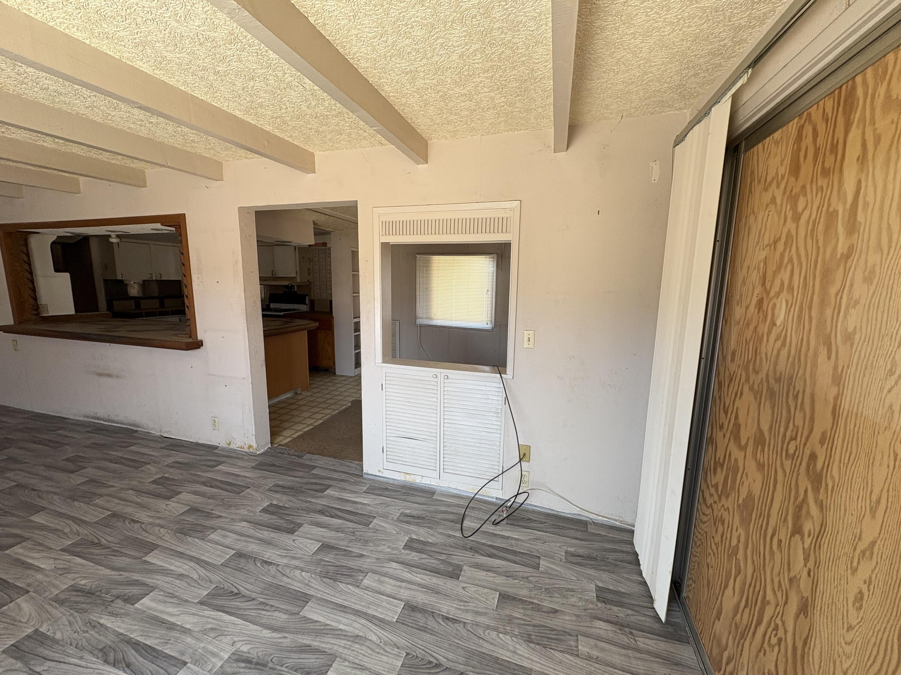 70260 Highway 111, Unit 148 Rancho Mirage, CA 92270 - Photo 29 of 36 a view of an empty room with wooden floor and a window