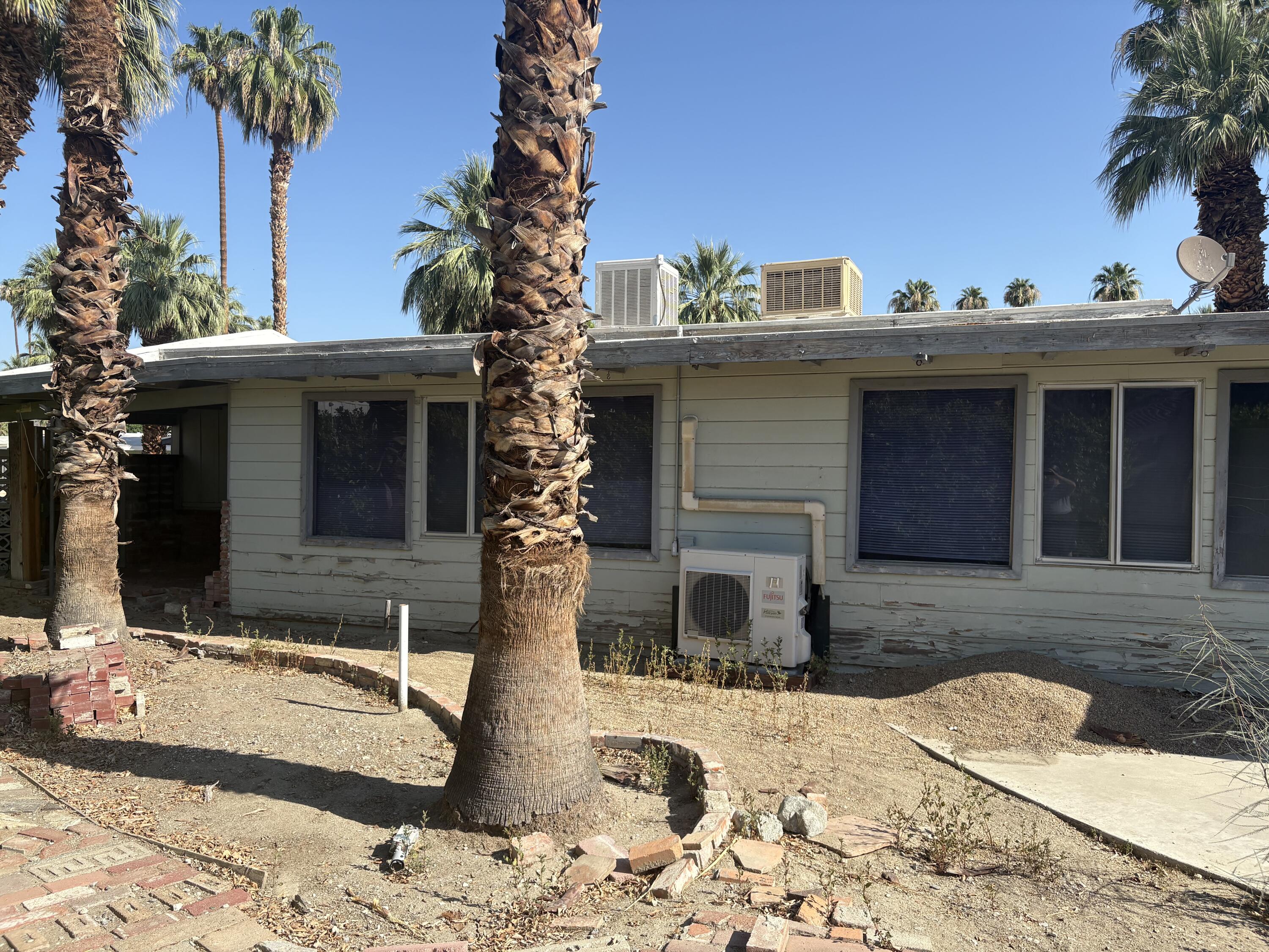 70260 Highway 111, Unit 148 Rancho Mirage, CA 92270 - Photo 7 of 36 a view of a house with a yard and garage