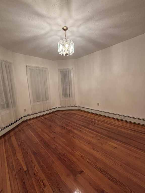 47 Middle Street, Unit 2 Boston, MA 02127 - Photo 4 of 13 wooden floor in an empty room with a window