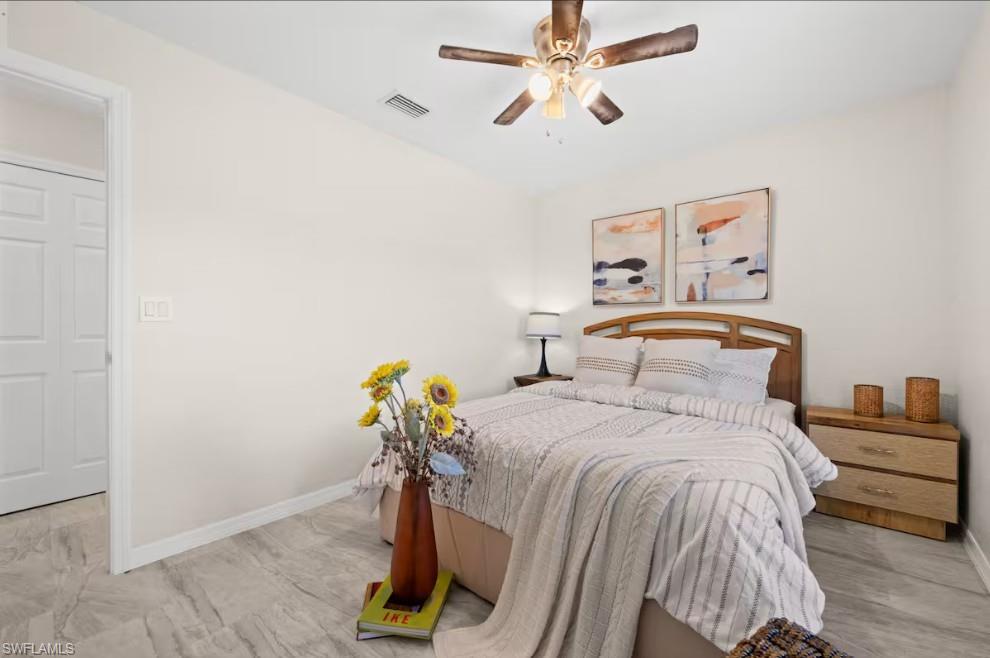 2715 Lee Street Punta Gorda, FL 33950 - Photo 25 of 50 a bedroom with a bed and a chandelier