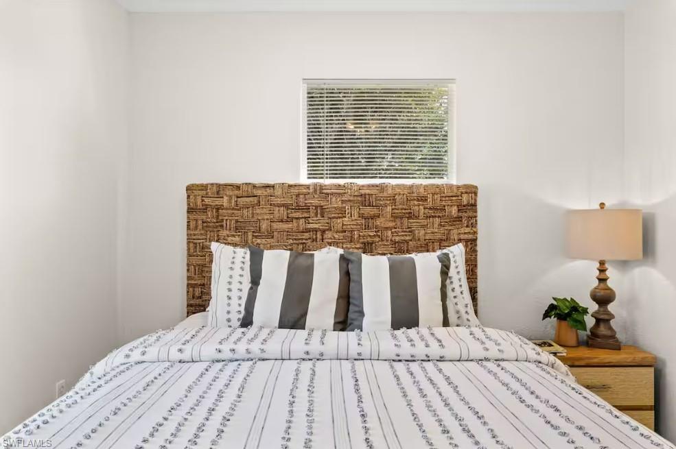 2715 Lee Street Punta Gorda, FL 33950 - Photo 30 of 50 a bed sitting in a bedroom next to a window