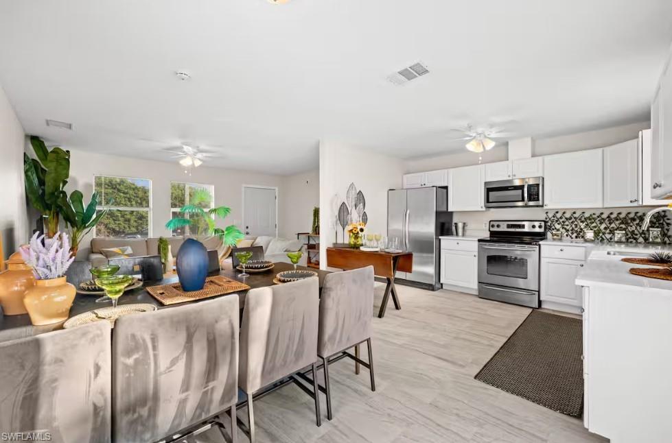 2715 Lee Street Punta Gorda, FL 33950 - Photo 35 of 50 a living room with stainless steel appliances furniture and a kitchen view