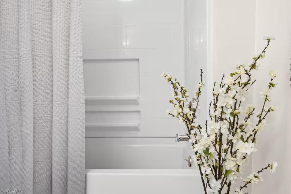 2715 Lee Street Punta Gorda, FL 33950 - Photo 42 of 50 a bathroom with a bathtub and shower curtain