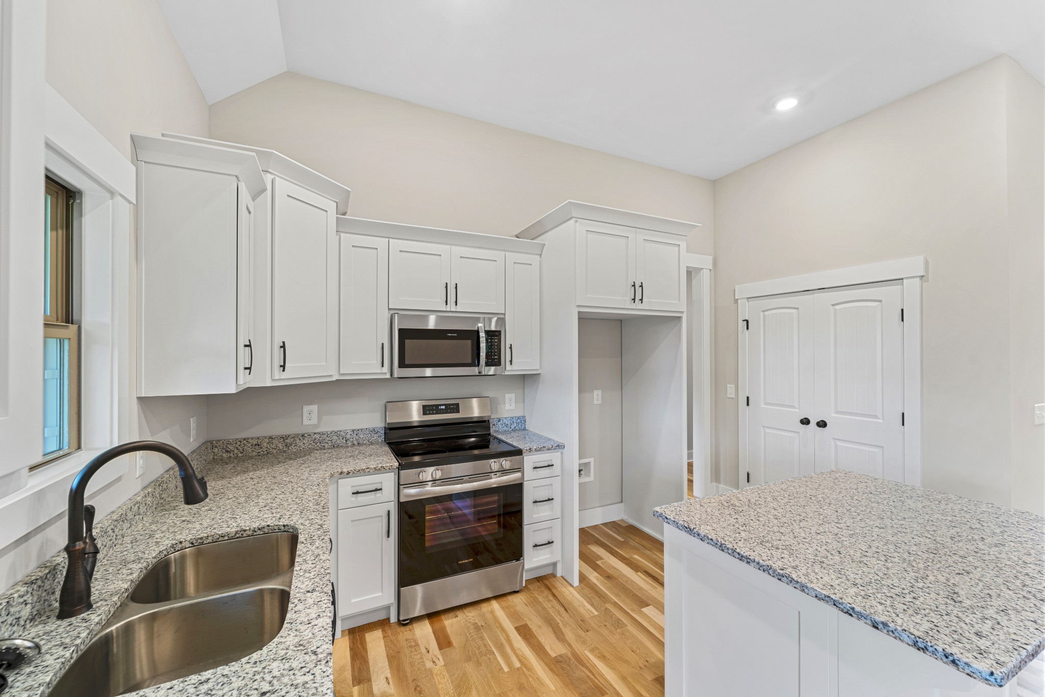 5751 Lakeview Road Springfield, TN 37172 - Photo 8 of 28 a kitchen with granite countertop a sink stainless steel appliances and white cabinets