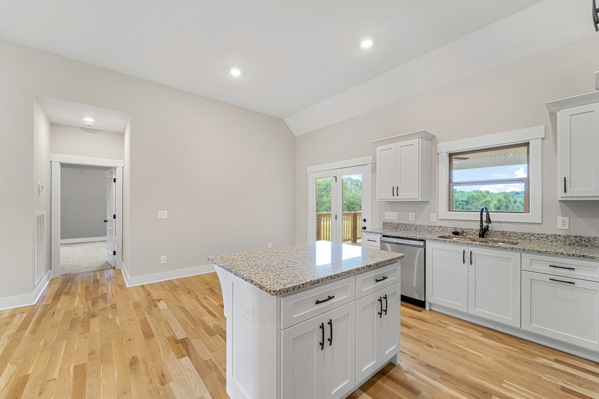 5751 Lakeview Road Springfield, TN 37172 - Photo 9 of 28 a kitchen with granite countertop a sink stainless steel appliances white cabinets and wooden floor