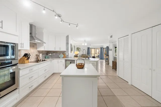 a kitchen with stainless steel appliances a stove a sink and a refrigerator