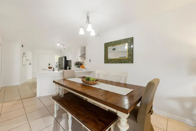 a kitchen with a stove and a dining table