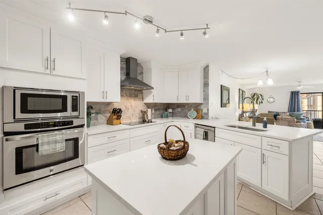 a kitchen with a sink a stove and cabinets