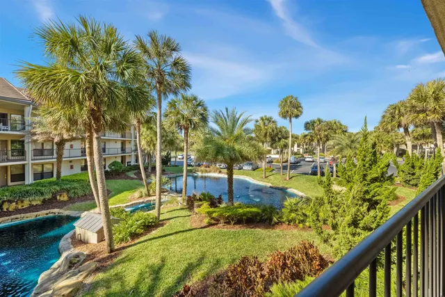 a view of a swimming pool with a patio and a garden