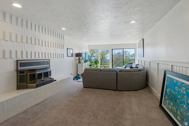 1900 North 100 East Provo, UT 84604 - Photo 26 of 49 Living area featuring a modern fireplace with an ornate insert, a textured white brick surround, and a coordinating hearth
