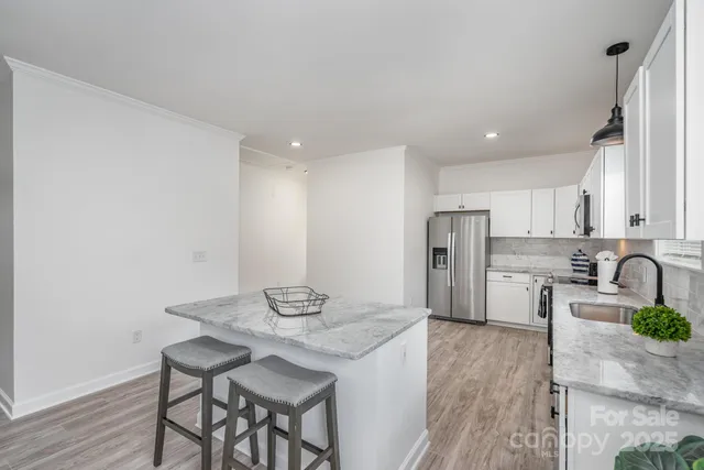 a view of a bedroom with a bed and a chandelier fan