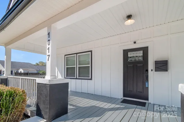 a living room with furniture and view of kitchen