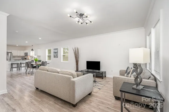 a dining room with furniture and wooden floor