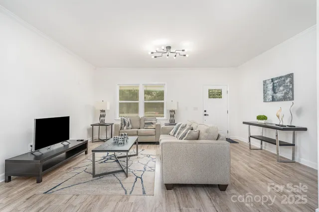 a kitchen with kitchen island a stove a table and chairs in it