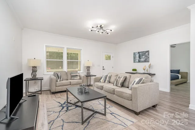 a kitchen with stainless steel appliances granite countertop a sink a stove a refrigerator with a dining table and chairs