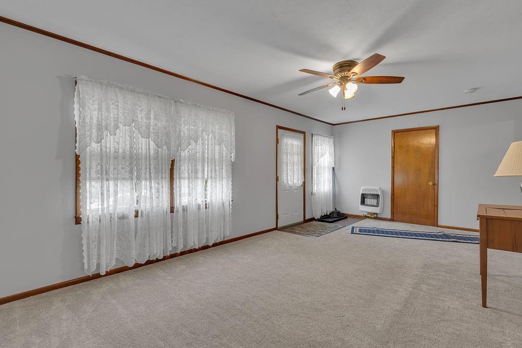 1196 Mercer Road Ellwood City, PA 16117 - Photo 12 of 31 a view of an empty room with chandelier fan and a window