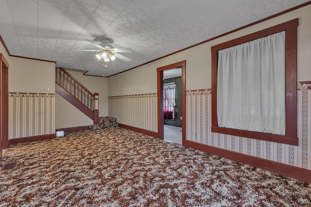 1196 Mercer Road Ellwood City, PA 16117 - Photo 16 of 31 a view of a hallway with a chandelier