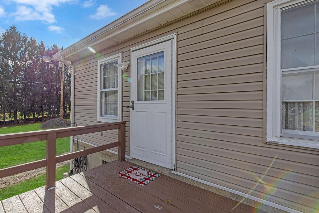 1196 Mercer Road Ellwood City, PA 16117 - Photo 2 of 31 a view of a porch with wooden floor and fence