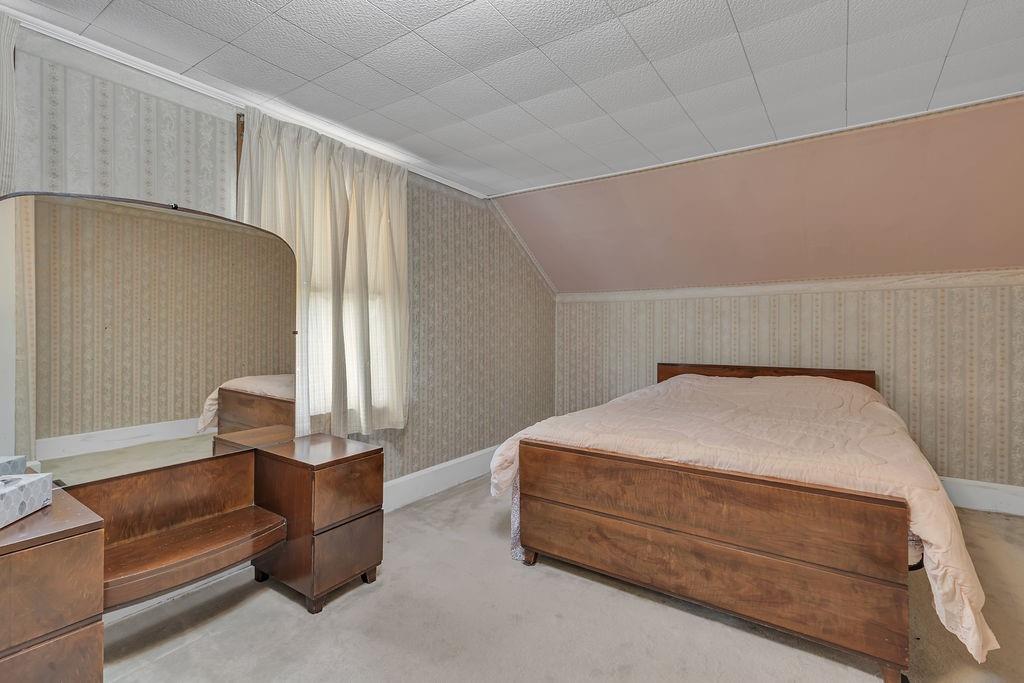 1196 Mercer Road Ellwood City, PA 16117 - Photo 24 of 31 a bedroom with a bed and a couch