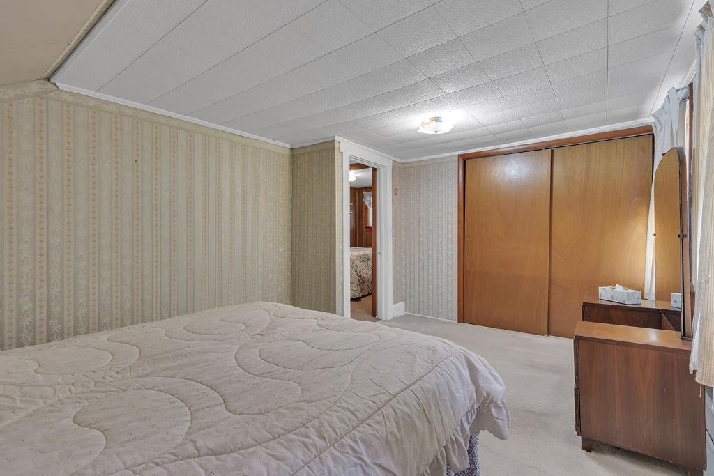 1196 Mercer Road Ellwood City, PA 16117 - Photo 25 of 31 a bedroom with a bed and a dresser