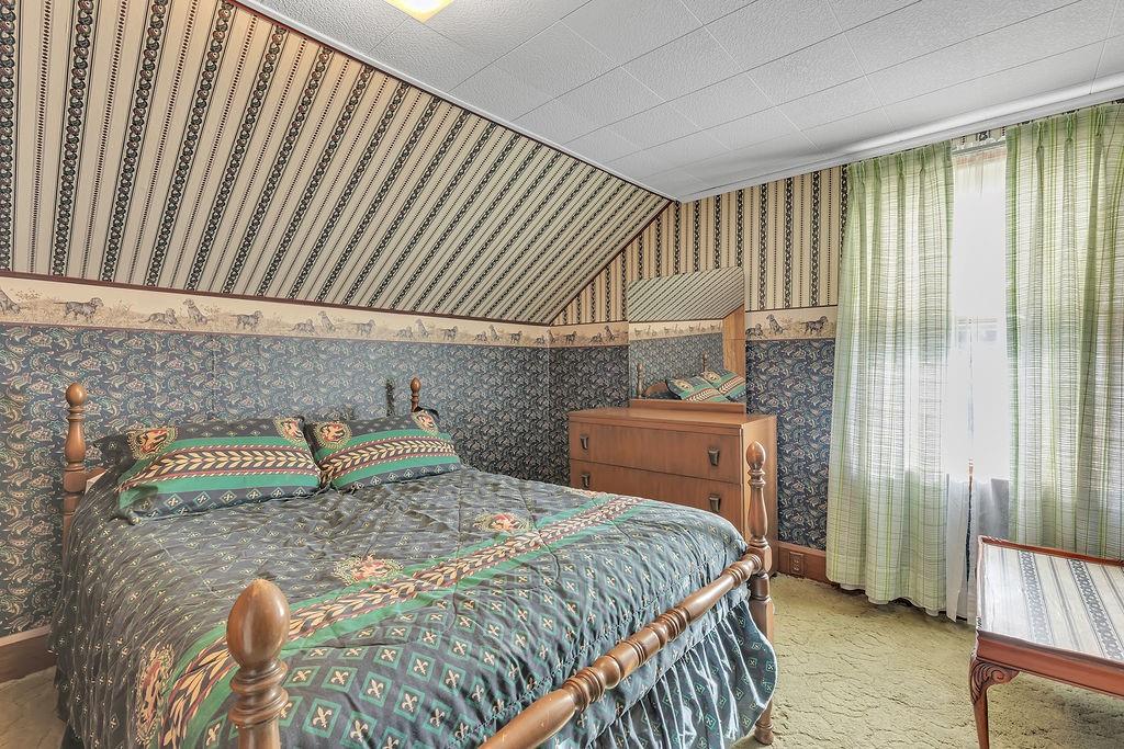 1196 Mercer Road Ellwood City, PA 16117 - Photo 26 of 31 a bedroom with a bed and a mirror