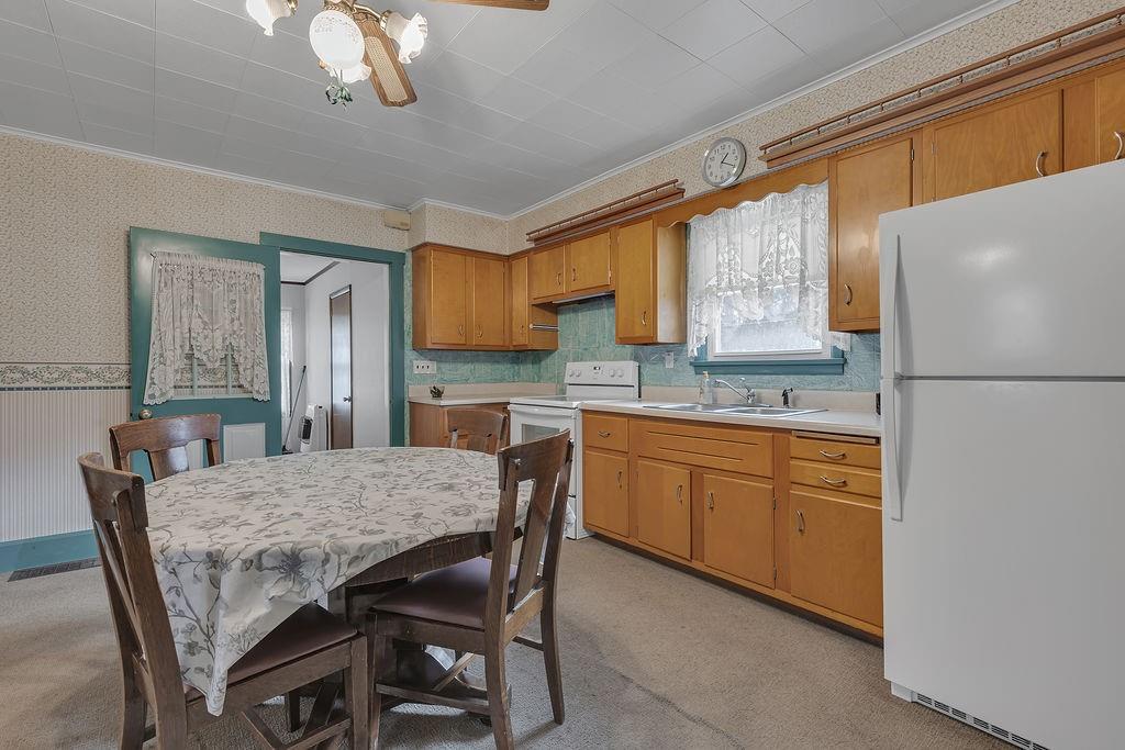1196 Mercer Road Ellwood City, PA 16117 - Photo 7 of 31 a kitchen with stainless steel appliances granite countertop a table chairs sink refrigerator and microwave