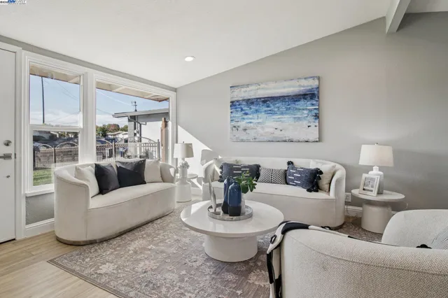 a living room with furniture and a large window