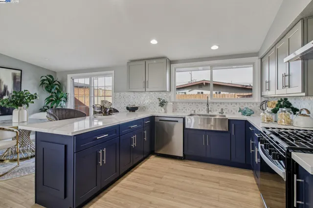a kitchen with a sink stove and cabinets