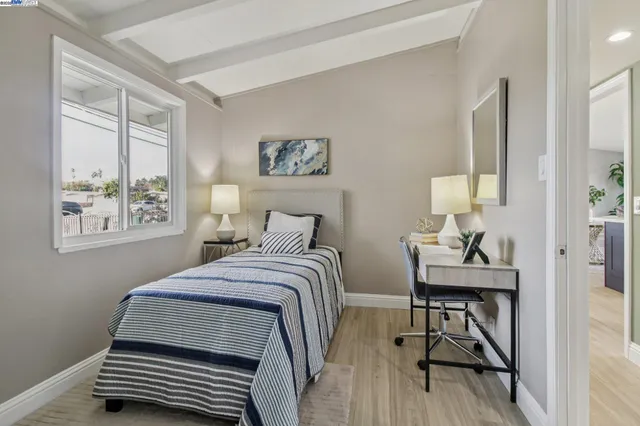 a bedroom with furniture and a window