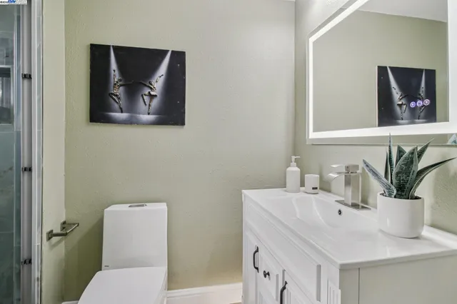 a bathroom with a toilet sink and mirror