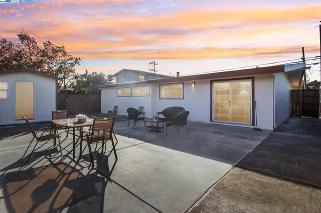a view of a house with patio and a garden